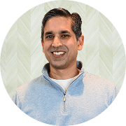 Andrew Abraham, MD, Physician at Fem Excel, smiling in gray sweater.