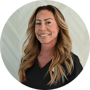 Dr. Lorna Brudie, DO, FACOG, FACS, Physician at Fem Excel, smiling in black medical uniform.