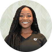 Jeni-Lyn Calabro, APRN, Nurse Practitioner at Fem Excel, smiling in black medical uniform.