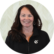 Karin Blais, FNP-C, Nurse Practitioner at Fem Excel, smiling in black zip-up uniform.