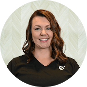 Kelly Donoho, MSN, FNP-BC, Nurse Practitioner at Fem Excel, smiling in black medical uniform.