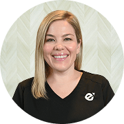 Meagan Gregory, MSN, APRN, FNP-C, Nurse Practitioner at Fem Excel, smiling in black medical uniform with glasses.