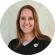 Sarah Garrand, FNP-BC, Nurse Practitioner at Fem Excel, smiling in black scrub top with grey undershirt.