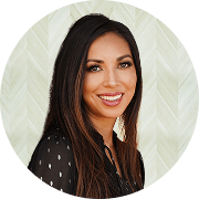 Tara Malone, FNP-BC, Nurse Practitioner at Fem Excel, smiling in black blouse with sheer sleeves.