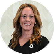 Paige McDonald, MSN, APRN, FNP-BC, Nurse Practitioner at Fem Excel, smiling in black polo with Fem Excel logo.