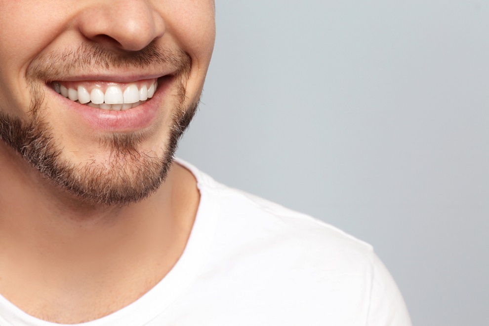 dental-health-heart-disease-young-man-with-beautiful-smile-on-grey-background dental-health-heart-disease-young-man-with-beautiful-smile-on-grey-background