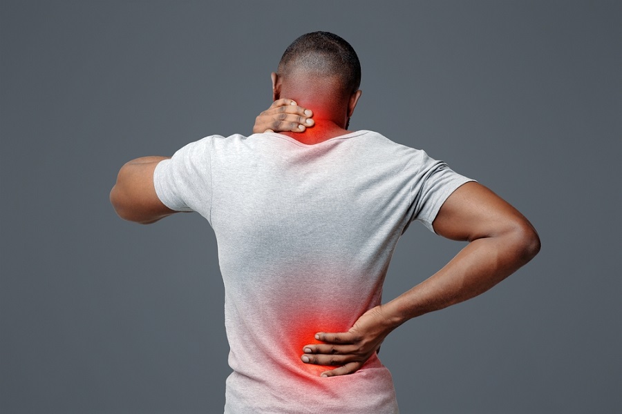 managing-chronic-pain-back-view-of-man-rubbing-his-painful-neck-and-back