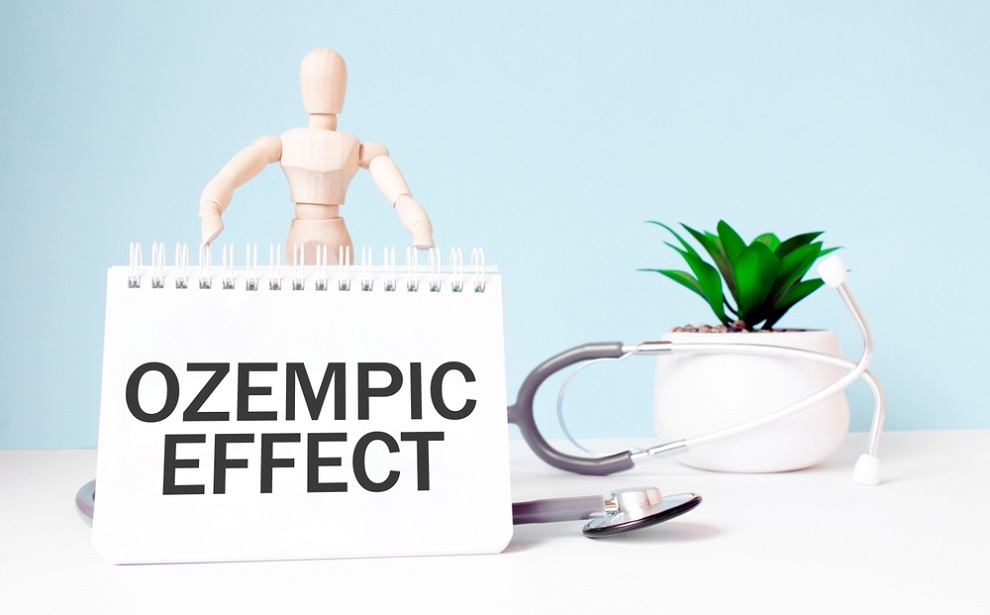 ozempic-and-testosterone-notepad-displaying-ozempic-effect-with-stethoscope-and-man-shaped-wooden-toy-in-background