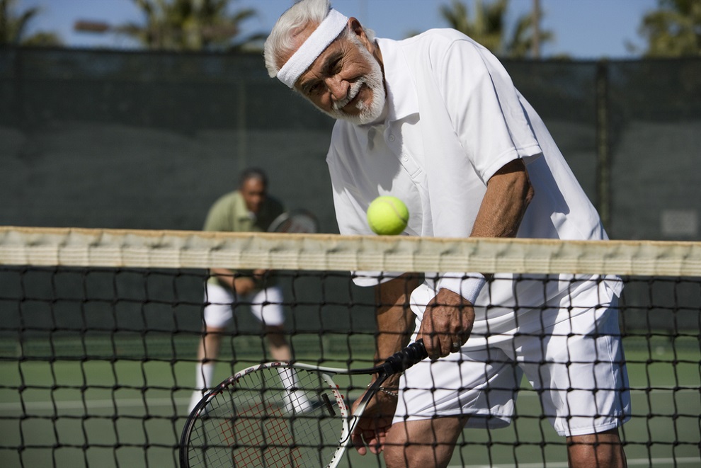 reaction-time-and-aging-senior-man-in-white-tshirt-shorts-headband-playing-tennis